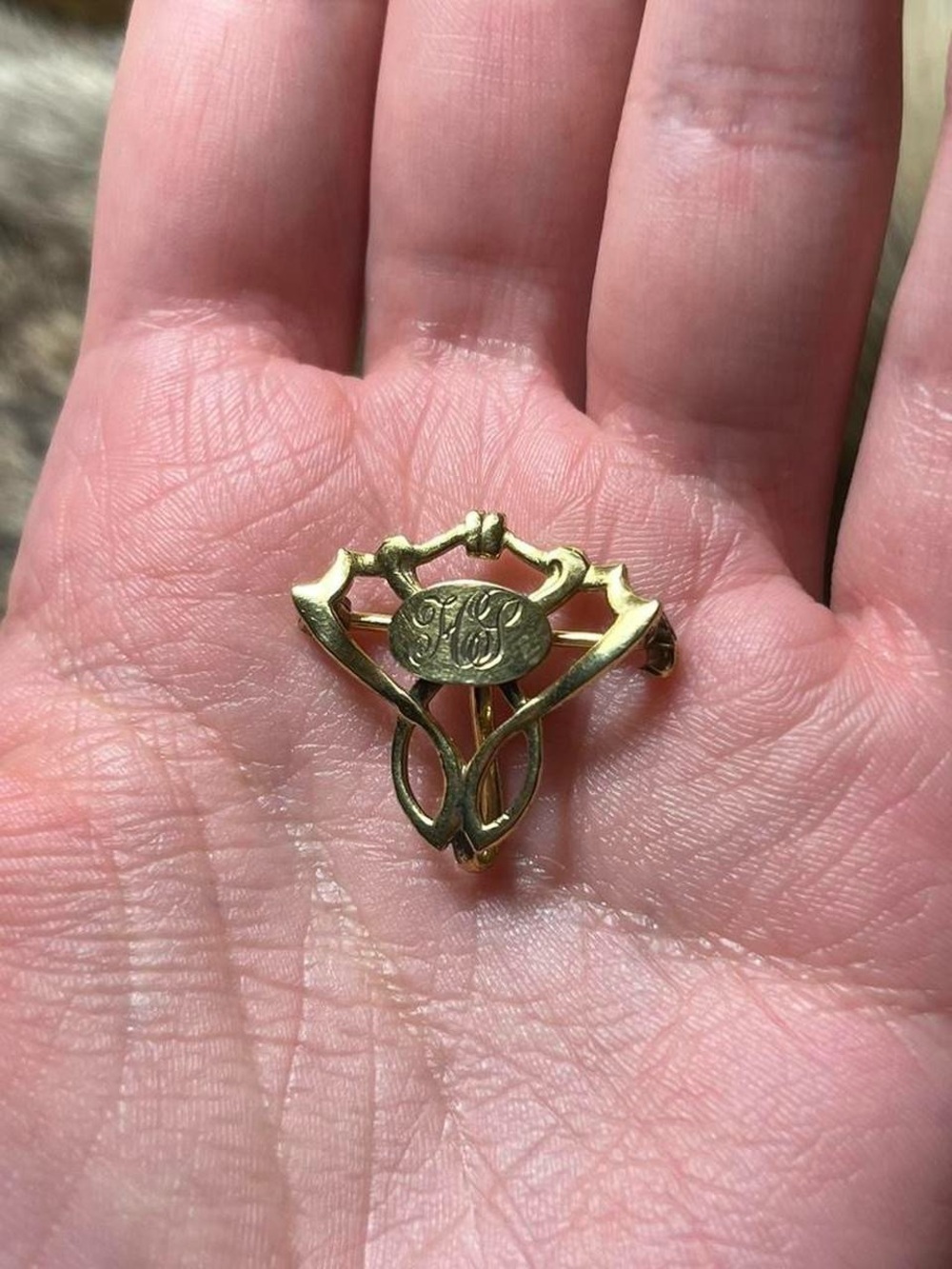 Gold toned charm brooch with engraved monogram HG